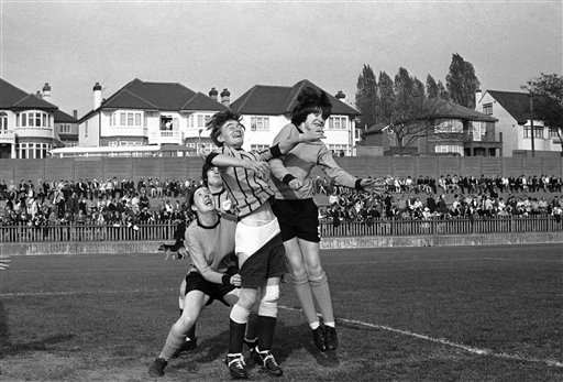 Great Britain London England vs Scotland Joan Tench of England, loses her pants during a scrimmage around the England goal during a women's soccer match in London, United Kingdom on Oct. 19, 1969, between England, (represented by Foden Ladies team), and Scotland, (represented by Westthorn United). From left, Jean Ramsey of Scotland who is hauling down the pants; Gillian Cornes of England, (rear in stripes); Joan Tench, and at right, Mary Davenport of Scotland. The football match ended in a 0-0 draw. (AP Photo/Dennis Lee Royle)