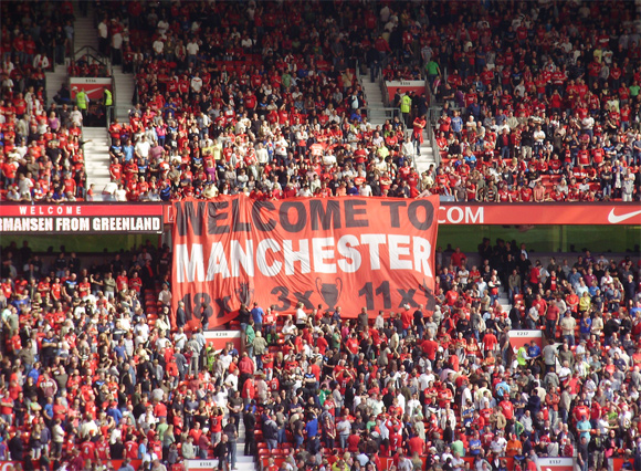 Welcome to Manchester Our Manchester theme continues, and United fans welcome City to their stadium with a not-so-subtle dig.